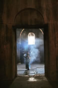 Armenian priest burns incense - Gandzasar’s Cathedral of St. John the Baptist.